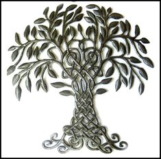 a metal tree with leaves and vines in the shape of a celtic knot on a white background