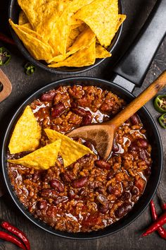 chili and tortilla chips in a skillet with wooden spoon on the side