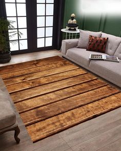 a living room area with a couch, chair and rug on top of the floor