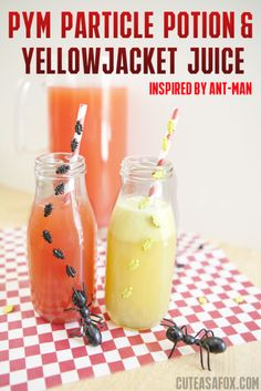 two jars filled with drinks sitting on top of a table