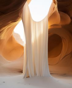 an abstract photo of the inside of a cave with light coming from it's windows