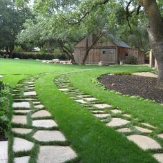 a stone path in the middle of a yard