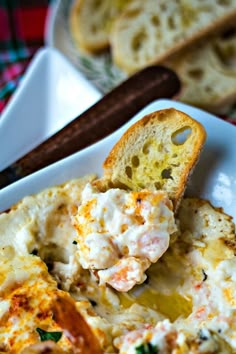 a white plate topped with food next to bread