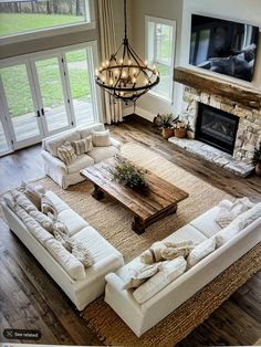 a living room with white couches and a fireplace