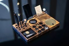 an assortment of makeup and beauty products displayed on a black table with lights in the background