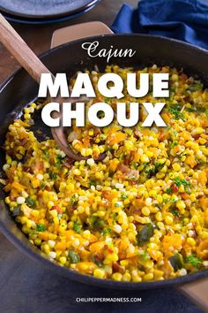 a skillet filled with corn and broccoli on top of a wooden table