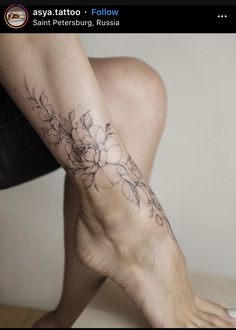 a woman's foot with flowers on it