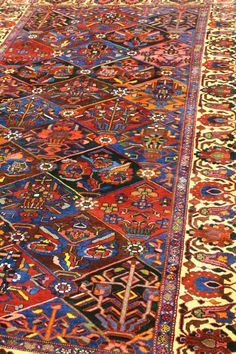 The antique Bakhtiari rug, originating from Persia around circa 1944, is an exquisite example of traditional tribal design. This specific rug showcases a prominent blue background and a complementary red border, with the primary color being blue. The material composition consists of wool woven onto a cotton foundation, a hallmark of durable and high-quality craftsmanship. Bakhtiari rugs are made by the Bakhtiari tribes of the Zagros Mountains in Iran, a region known for its rugged landscape and Artesian Rug, Rugged Landscape, Art Deco Carpet, Zagros Mountains, Red Palette, Bakhtiari Rugs, Turkish Style, Persian Carpets