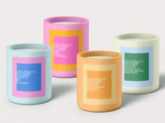 three different colored candles sitting next to each other