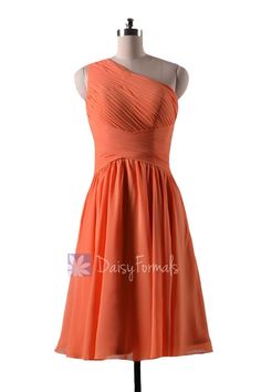 an orange bridesmaid dress on a mannequin