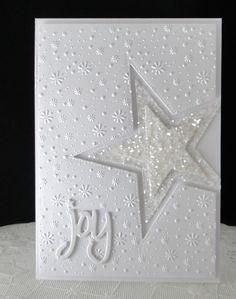 a white card with a star on it and the word joy written in cursive writing