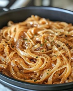 a bowl filled with pasta and sauce on top of a table