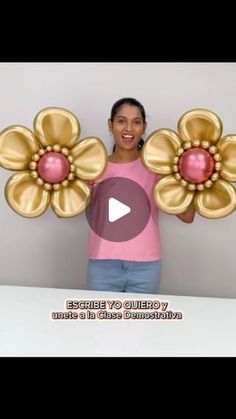 a woman holding two large flowers in front of her face with the caption's video below