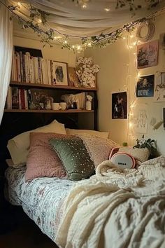 a bed with lots of pillows and blankets on top of it