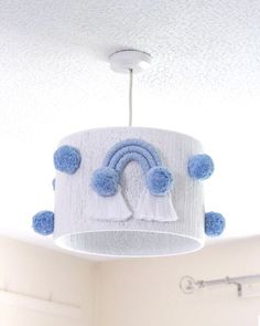 a blue and white cake hanging from the ceiling in a room with a light fixture