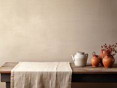 three vases are sitting on a wooden table