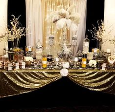 a table topped with lots of white flowers and candles