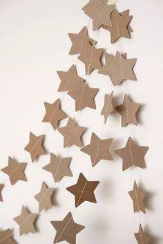 some brown paper stars hanging from a string