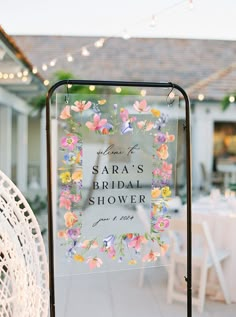 a sign that says sara's bridal shower in front of a white table