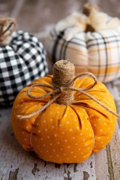 three small pumpkins with twine tied to them