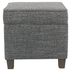 a grey ottoman with wooden legs