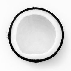 a whole coconut is shown on a white background with black trimming around the inside