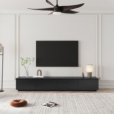 a flat screen tv mounted on the wall in a living room with white walls and flooring