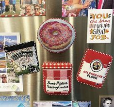 there are many magnets on the refrigerator door that have been decorated with pictures and sayings