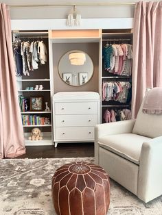 a baby's room with an ottoman, dresser and closet