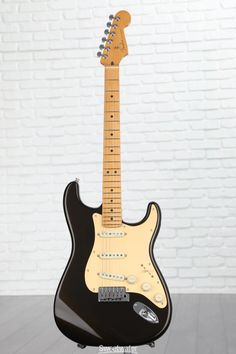 an electric guitar sitting on top of a stand