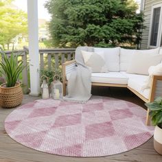 a pink and white rug sitting on top of a wooden deck