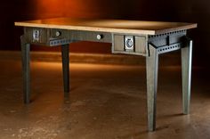 a wooden table with two drawers on each side and one drawer at the top, in front of a dark background