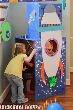 two children playing in a space themed room