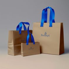 two brown bags with blue handles are sitting next to each other