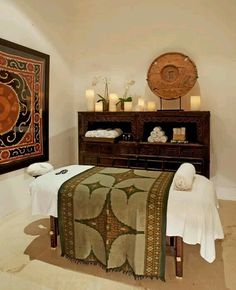 a spa room with towels and candles on the table