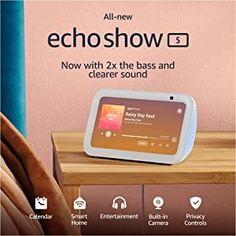 an advertisement for echoshow is displayed on a table next to a bed and chair