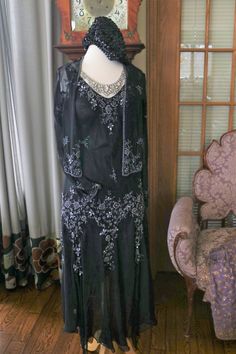 Black silk chiffon beaded Flapper dress, approx sizing from 4-8 (bias cut) Gown does include the matching beaded jacket. More pics on FB:https://www.facebook.com/pg/RetroVintageWeddings1920s1930s/photos/?tab=album&album_id=2623216997774327 1920s Embellished Black Dress, 1920s Black Embellished Dress, Black Sequin Flapper Dress For Wedding, Elegant Floor-length Flapper Evening Dress, Black Gatsby Style Wedding Dress, Elegant Floor-length Flapper Dress, Black Flapper Dress For Wedding, Elegant Fitted Floor-length Flapper Dress, 1920s Style Black Flapper Dress For Wedding