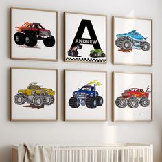 four monster trucks are hung on the wall above a crib