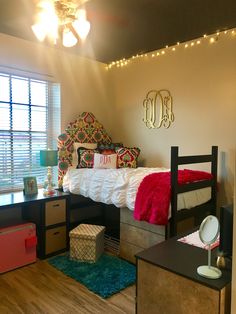 a bedroom with a bed, desk and drawers