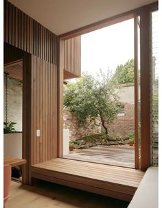 the inside of a house with wooden floors and large sliding glass doors that open up to an outside patio area