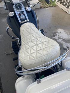 a close up of a motorcycle with a speedometer on the handlebars and seat