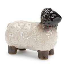 a ceramic sheep figurine on a white background