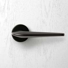 a black door handle on a white wall