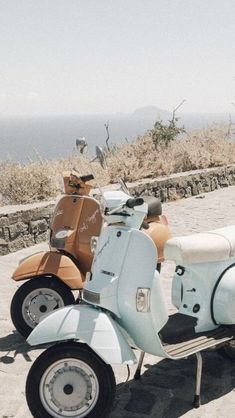 two mopeds parked on the side of a road