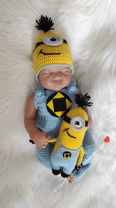 a newborn baby wearing a crocheted hat and holding a stuffed toy in it's arms