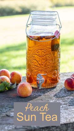 peach sun tea in a mason jar on a picnic table with fresh peaches around it