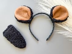 two ears are shown on top of the headband and one is made out of black material