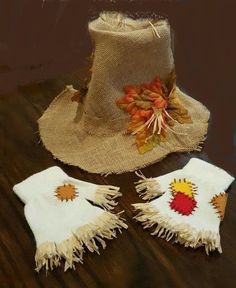 two hats with tassels are sitting on a wooden table next to a burlock