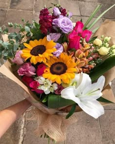 a bouquet of flowers sitting on top of a brown paper wrapped in burlock