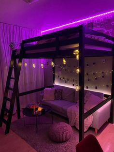 a loft bed is lit up with purple lights in the corner and pillows on the floor